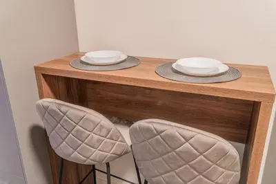 a wooden table with two plates and two chairs at 9 Nine - Luxury Apartments & Suites in Belgrade