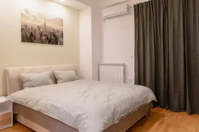 a bedroom with a bed and a window at AirMi hotel in Surčin