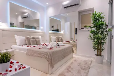 a bedroom with two beds and a mirror at Alex Central Apartments in Belgrade