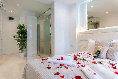 a bedroom with a bed with red roses on it at Alex Central Apartments in Belgrade
