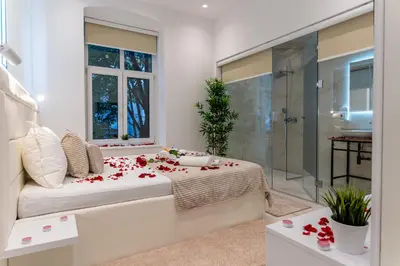 a bedroom with a bed with roses on it at Alex Central Apartments in Belgrade