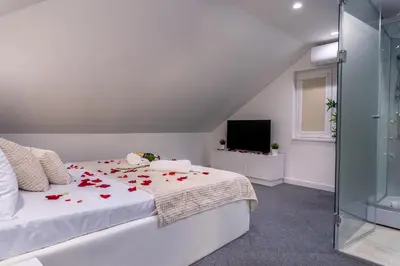a bedroom with a bed with red roses on it at Alex Central Apartments in Belgrade