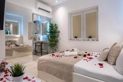 a bedroom with a bed with red flowers on it at Alex Central Apartments in Belgrade