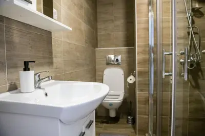 a bathroom with a sink and a toilet at APARTMAN TEA 3 in Čukarica