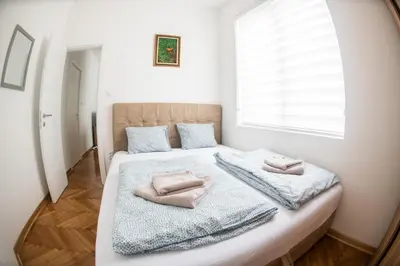 a bedroom with a bed with two pillows on it at APARTMAN TEA 3 in Čukarica