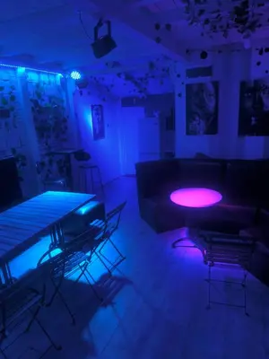 a room with a couch and a table with purple lights at cunami kucica sa bazenom in Belgrade
