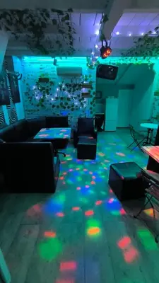 a room with a couch and tables and lights on the floor at cunami kucica sa bazenom in Belgrade