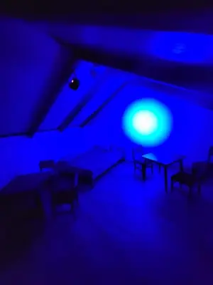 a blue room with chairs and a table in it at cunami kucica sa bazenom in Belgrade