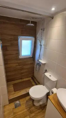 a bathroom with a toilet and a window in it at Sopot Paradise in Sopot