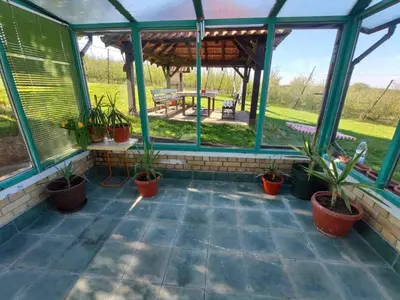 a screened in porch with potted plants and a gazebo at Sopot Paradise in Sopot