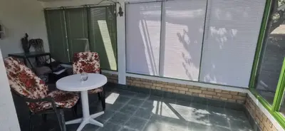 a room with a table and two chairs and windows at Sopot Paradise in Sopot