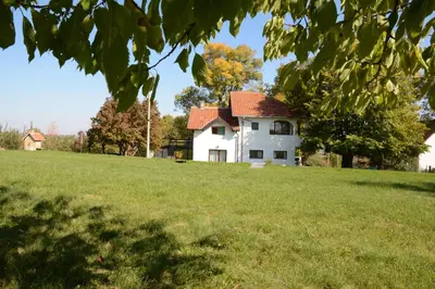 a white house on a hill with a grass field at Sopot Paradise in Sopot