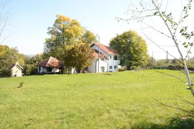 a large white house in a field of grass at Sopot Paradise in Sopot