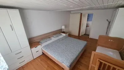 a small bedroom with a bed and white walls at Sopot Paradise in Sopot