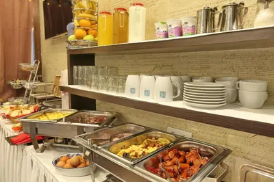 a buffet line with many different food items on shelves at Garni Hotel Vozarev in Belgrade