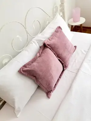 a white bed with two pillows on it at VIKONT studio apartment with parking 5 eur per day in Belgrade