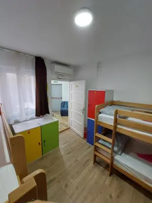 a dorm room with two bunk beds and a hallway at Hostel Inn Downtown in Belgrade