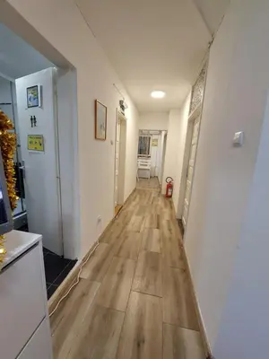 a hallway with a hard wood floor in a house at Hostel Inn Downtown in Belgrade