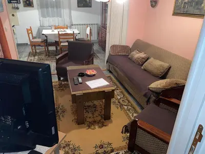 a living room with a couch and a table at Verica in Vračar (historical)
