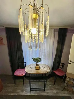 a dining room with a table and a chandelier at Verica in Vračar (historical)