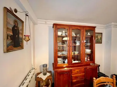 a wooden cabinet with dishes in it in a room at Verica in Vračar (historical)