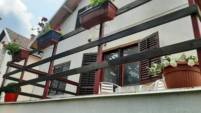 a building with potted plants and windows on it at Green sanctuary 30 min from downtown Belgrade in Donja Ralja