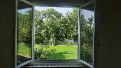 an open window with a view of a yard at Green sanctuary 30 min from downtown Belgrade in Donja Ralja