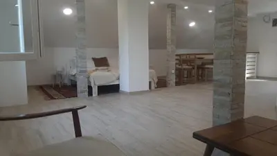a living room with a bed and a table in a room at Green sanctuary 30 min from downtown Belgrade in Donja Ralja
