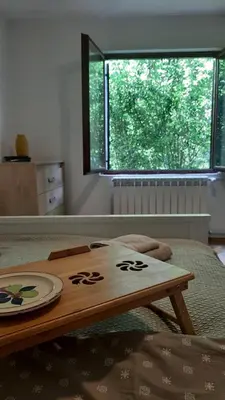 a wooden table with a plate on top of a bed at Green sanctuary 30 min from downtown Belgrade in Donja Ralja