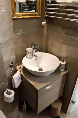 a bathroom with a white sink and a mirror at Crown apartman in Belgrade