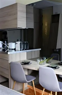 a kitchen with a table and chairs in a kitchen at Crown apartman in Belgrade