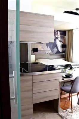 a bedroom with a desk and a bed and a desk at Crown apartman in Belgrade