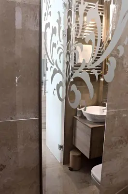 a bathroom with a toilet and a sink and a mirror at Crown apartman in Belgrade
