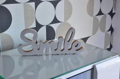 a wooden sign sitting on top of a counter at Guest House Atena in Nova Pazova