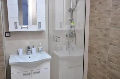 a bathroom with a sink and a shower at Guest House Atena in Nova Pazova