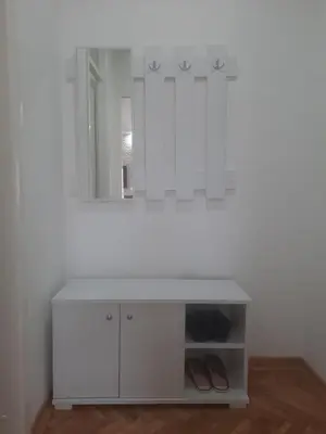 a white bathroom with a sink and a mirror at Apartman Janković in Arandjelovac