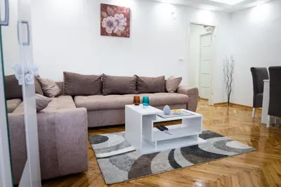 a living room with a couch and a table at Apartman Janković in Arandjelovac