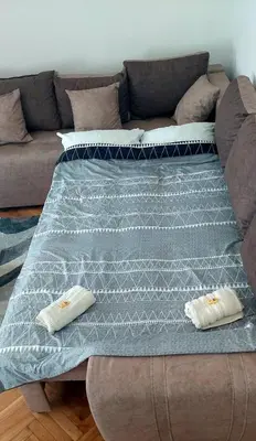 a bed with two pillows on top of it at Apartman Janković in Arandjelovac