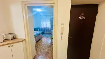 a door leading into a room with a living room at Sweet Venac in Belgrade