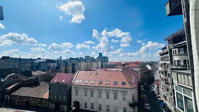 a view of a city with buildings and a blue sky at Sweet Venac in Belgrade