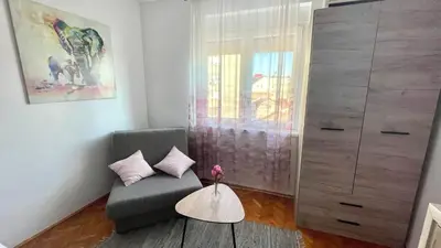a living room with a chair and a dresser at Sweet Venac in Belgrade