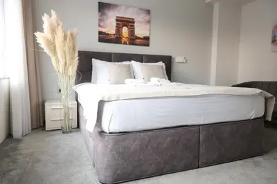 a bedroom with a large bed with white sheets at Templum Appart-Hotel -SELF CHECK IN - Slavija square in Belgrade