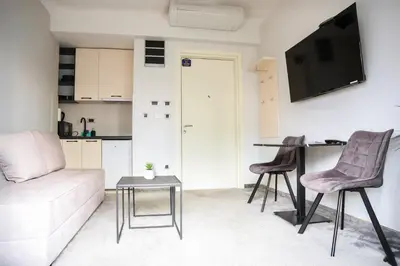 a living room with a couch and a table at Templum Appart-Hotel -SELF CHECK IN - Slavija square in Belgrade