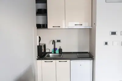 a kitchen with white cabinets and a sink at Templum Appart-Hotel -SELF CHECK IN - Slavija square in Belgrade