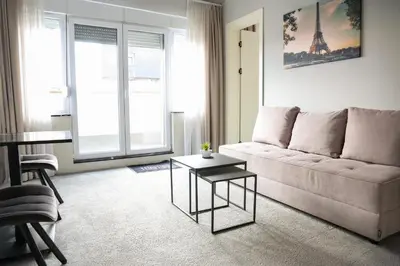 a living room with a couch and a table at Templum Appart-Hotel -SELF CHECK IN - Slavija square in Belgrade