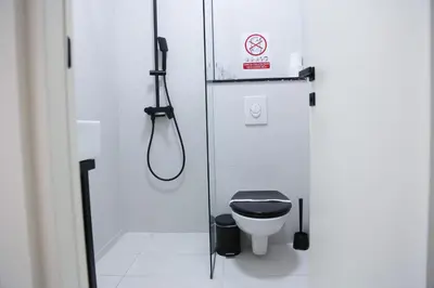 a bathroom with a shower and a toilet in a stall at Templum Appart-Hotel -SELF CHECK IN - Slavija square in Belgrade