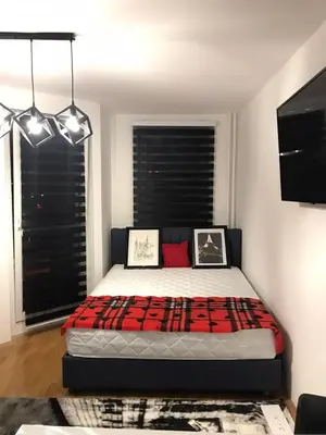 a bedroom with a bed with a red and black blanket at Zorz in Belgrade