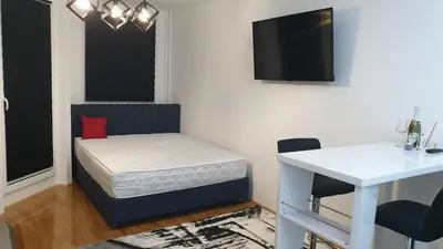a room with a bed and a table and a desk at Zorz in Belgrade