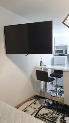a desk with two chairs and a microwave on a wall at Zorz in Belgrade