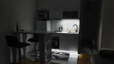 a kitchen with a sink and a counter with a stove at Zorz in Belgrade